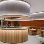 zooco estudio wraps restaurant inside in spain with clay scales and semi-transparent pipes