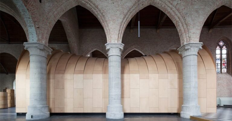 dhooge & meganck installs wooden ‘house of silence’ within renovated church in belgium