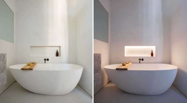 تم بناء مكان للرفوف مع إضاءة LED مخفية في الجدار بجوار حوض الاستحمام المستقل في هذا الحمام الحديث ، مما يسمح بوضع أشياء مثل الصابون في متناول اليد.