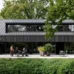 studio] [space nestles black barn-shaped office into the dutch landscape