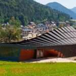 undulating tiered rafter by studio beltrame envelops ski school in italy