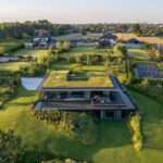 A Large Green Roof Covers This Riverside Home