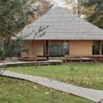 charly jolliet’s umbrella-shaped canopy in switzerland spotlights traditional wood cladding