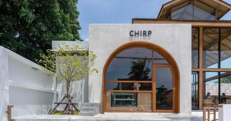 The Large Arch Window In Front Of This Cafe Offers A Glimpse Of The Creative Interior