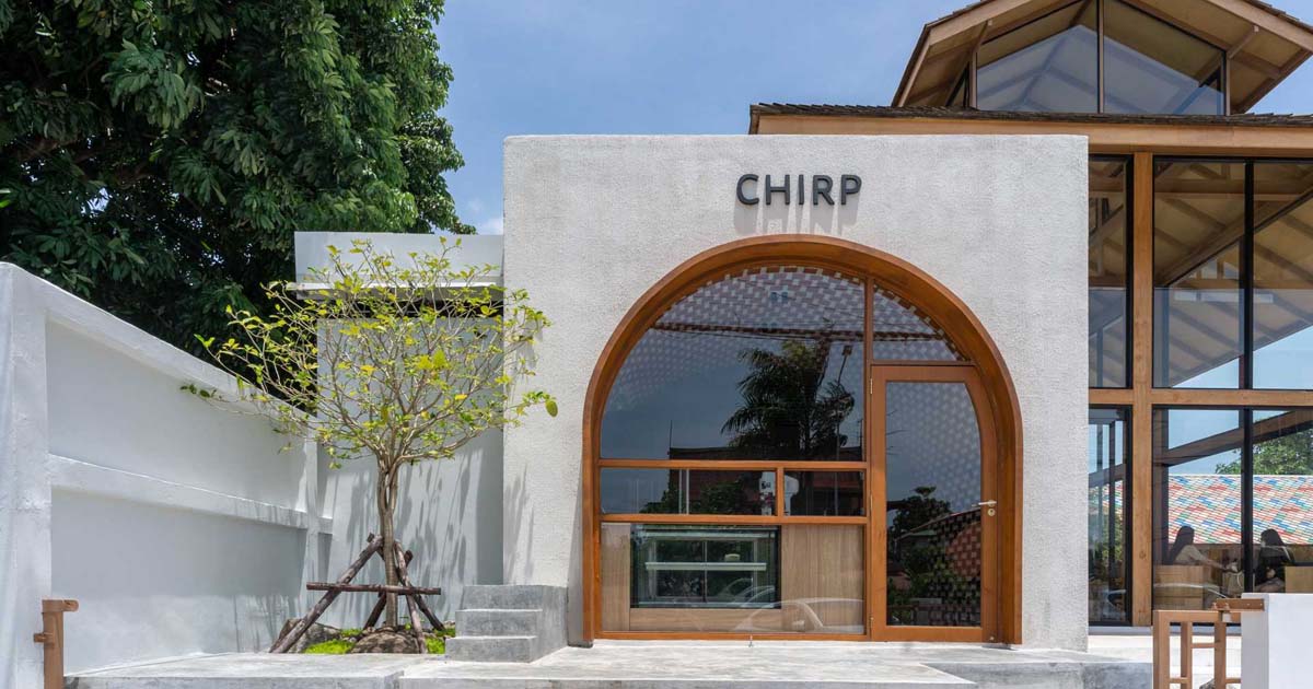 The Large Arch Window In Front Of This Cafe Offers A Glimpse Of The Creative Interior