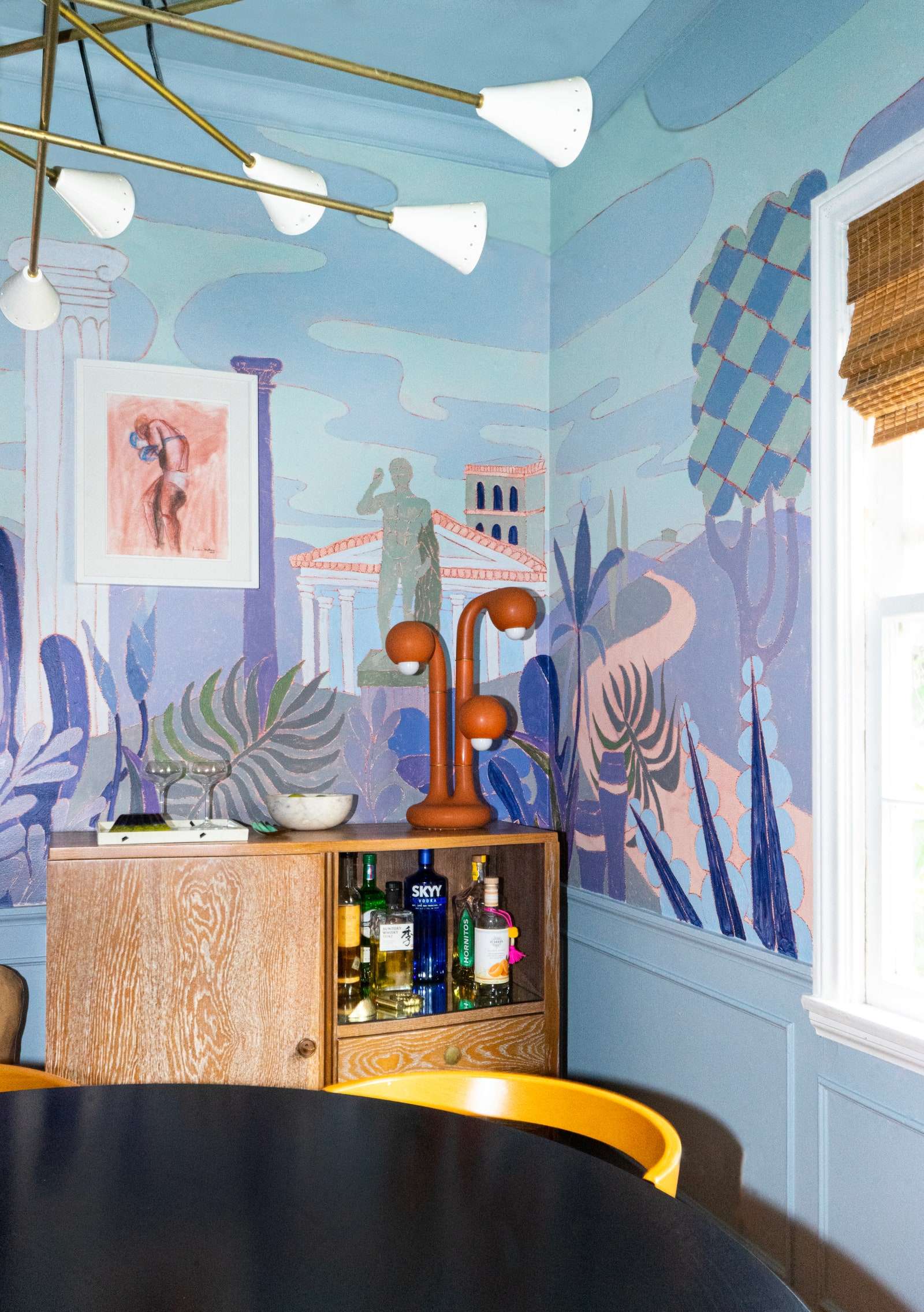 The artist and his husband Jake decided to limit the amount of artwork hung in the dining room post mural installation....