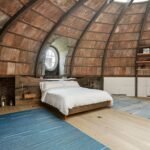 90s supermodel hotspot 240 Centre Streets penthouse apartment bedroom with skylight bookshelves round window bed