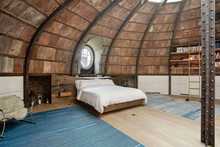 90s supermodel hotspot 240 Centre Streets penthouse apartment bedroom with skylight bookshelves round window bed