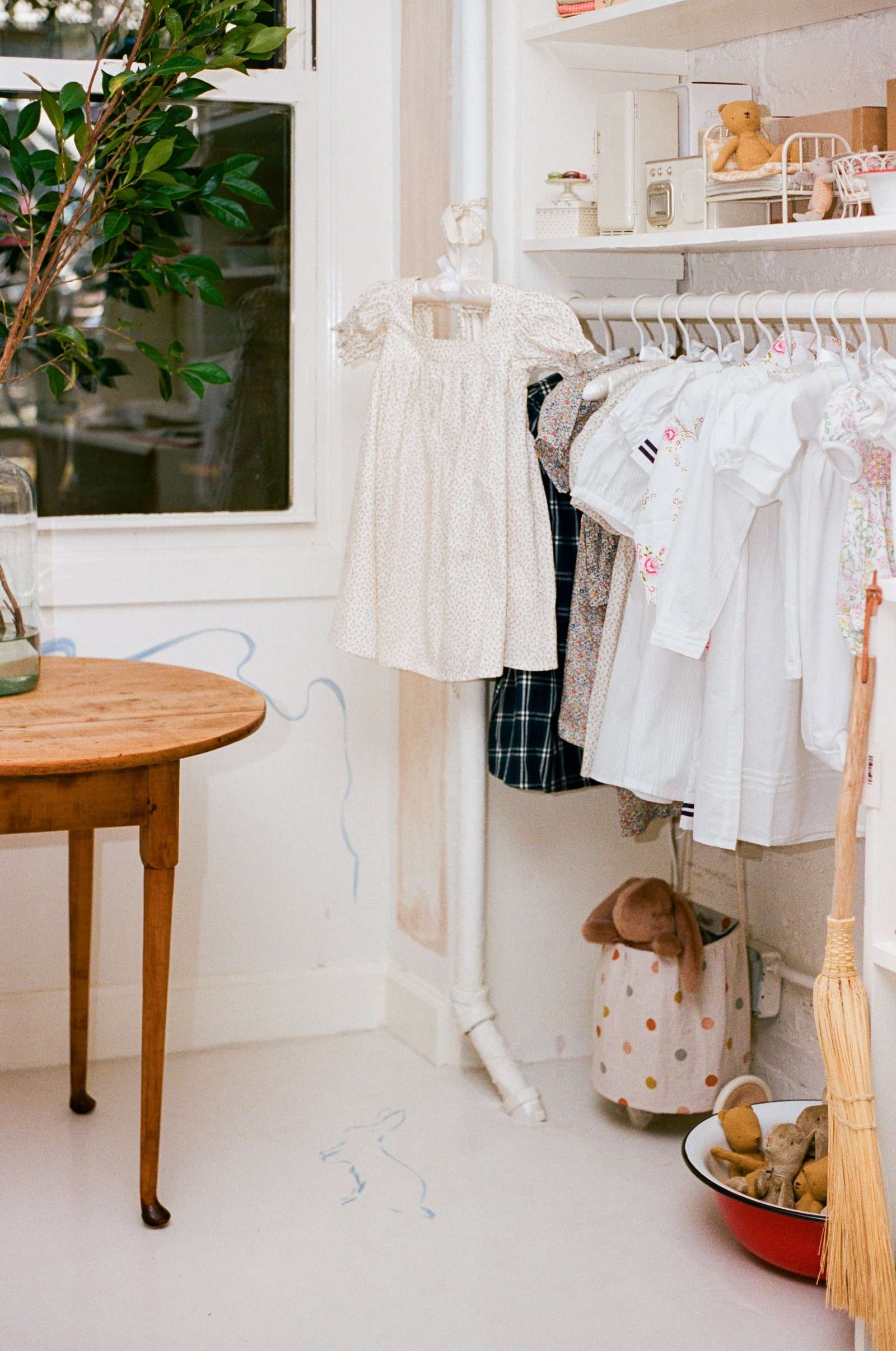A corner of childrens clothing and accessories toward the front of the store.