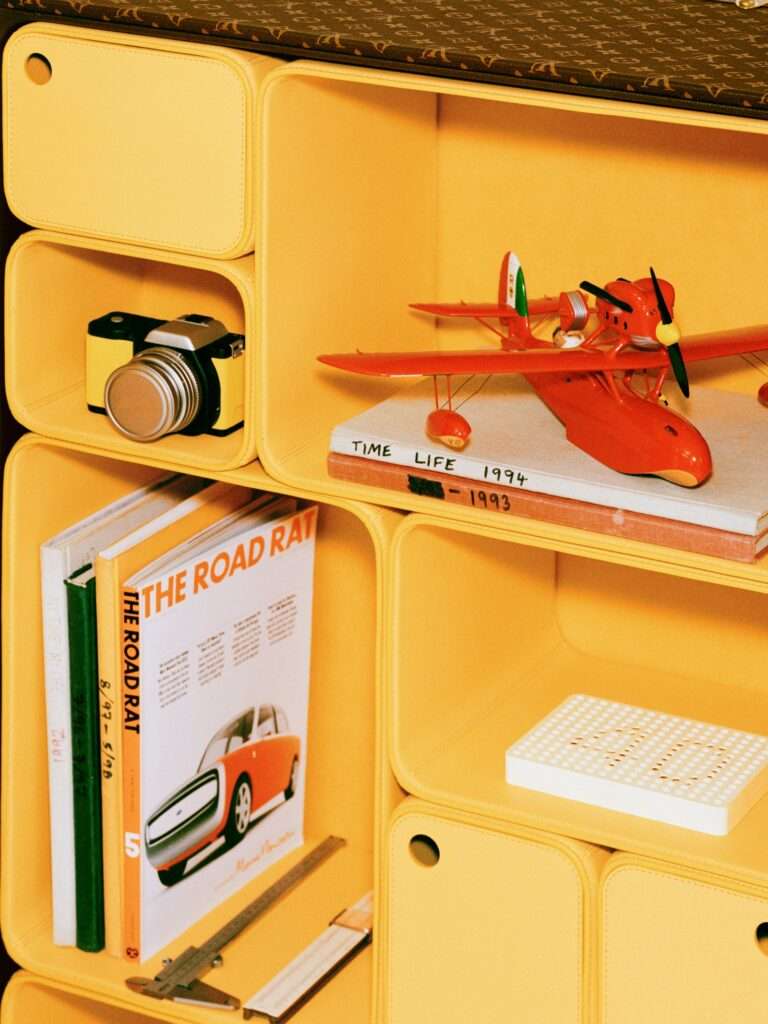 The piece is outfitted with modular compartments to store and display ones assorted keepsakes.