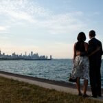 Barack and Michelle Obama side by side at Chicago lakefront looking at city skyline