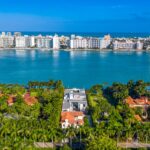 aerial shot of a plot of land with two homes on it on an island
