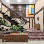 Retro interior of The Brady Bunch house with brick paver landing floating staircase credenza horse figurine