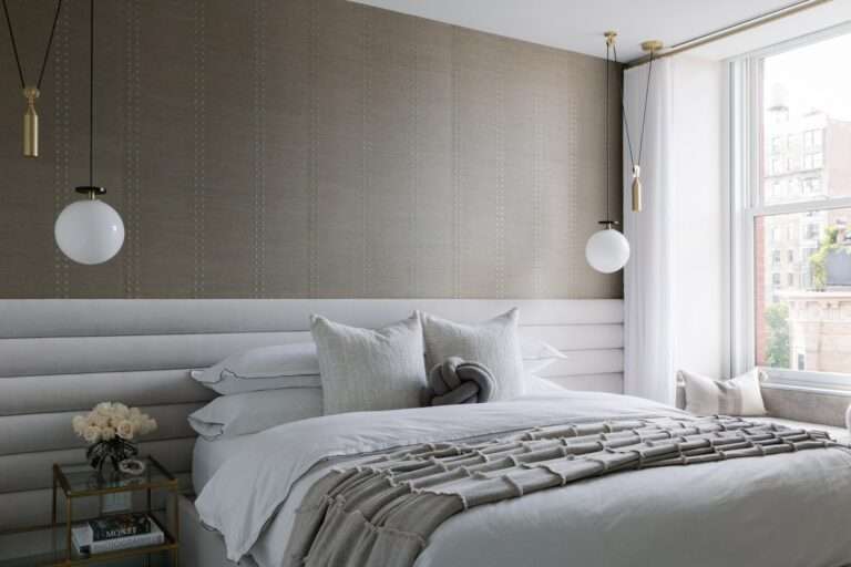 Grey bedroom with bed hanging lights and window