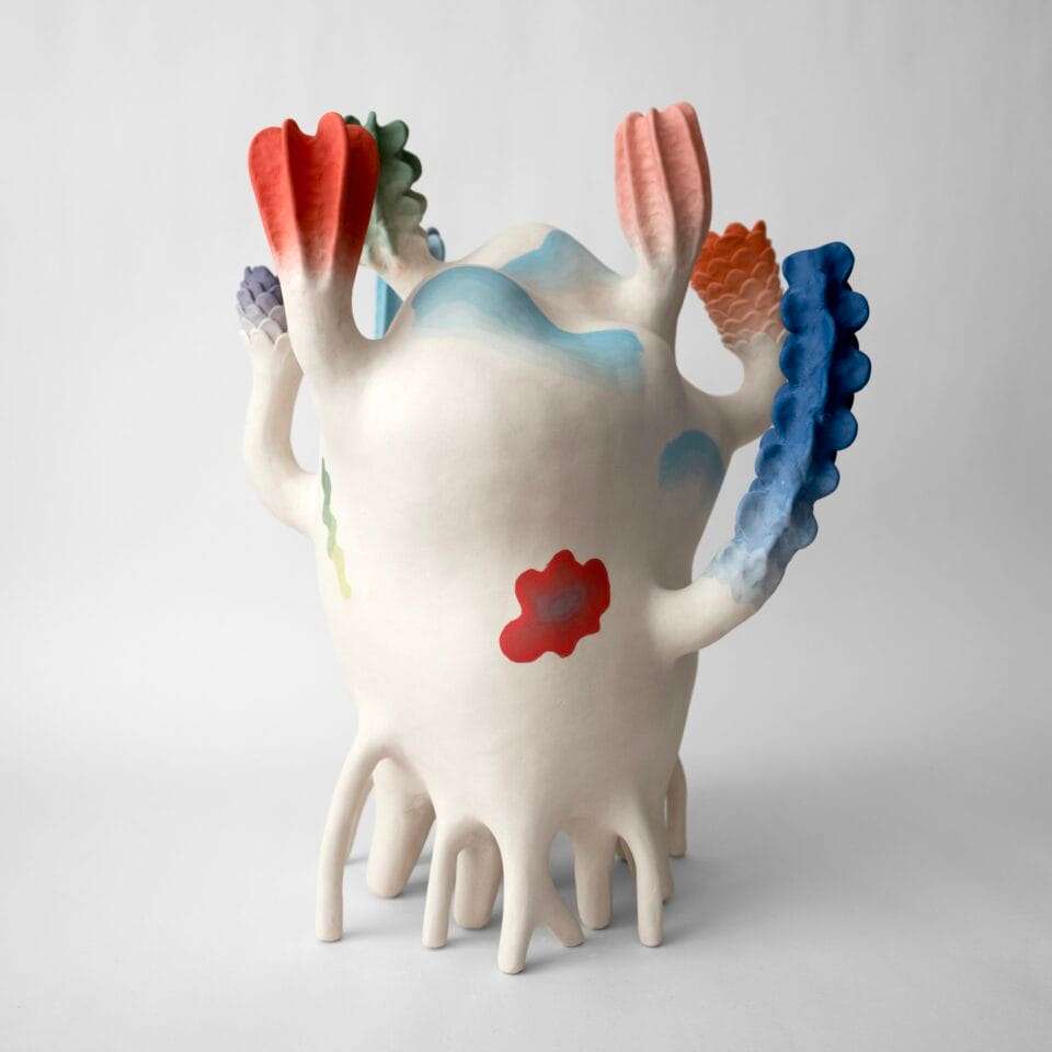 an abstract, colorful ceramic sculpture with nature-inspired elements evocative of coral or flowers