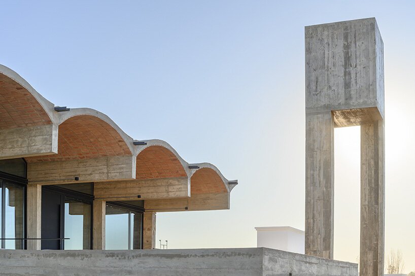 airy vaulted roofs crown robust concrete base of cristián nanzer's residence in argentina