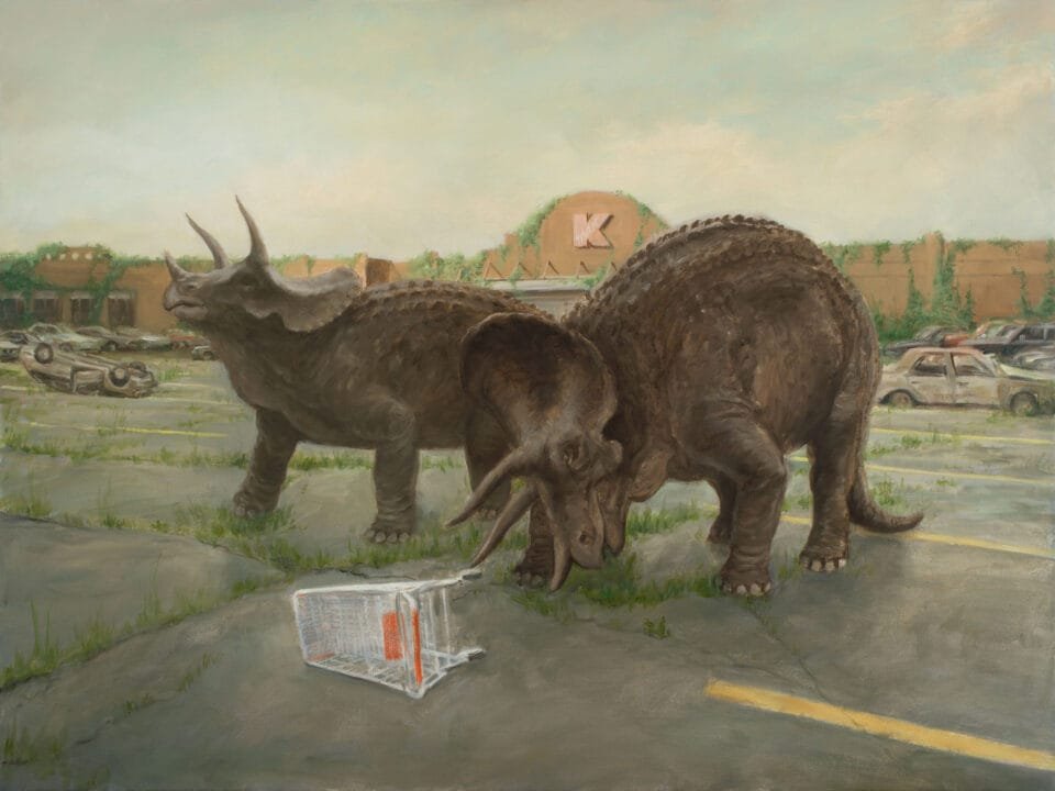 a pair of Triceratops stand in the parking lot in front of an abandoned K-Mart