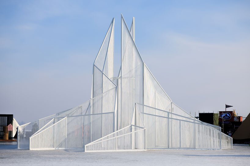 white flame installation's sharp geometry resembles ice crystals along lake in china