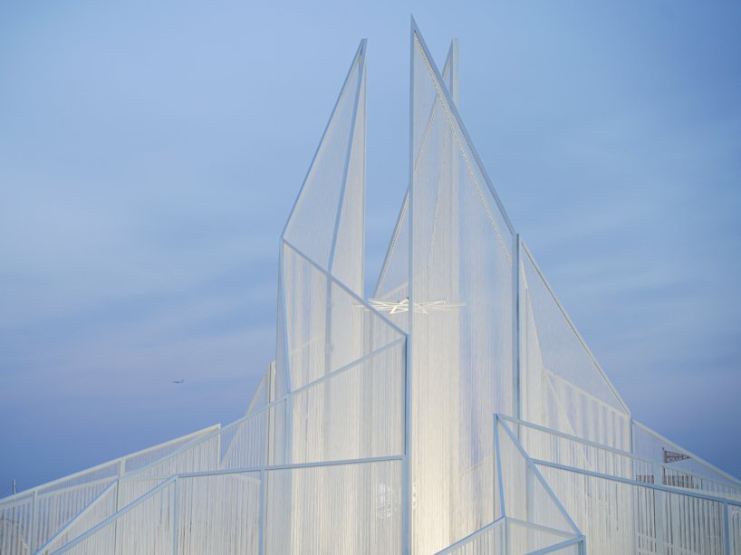 white flame installation's sharp geometry resembles ice crystals along lake in china