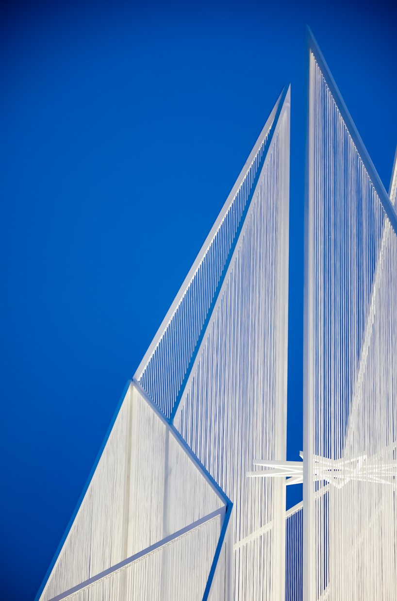 white flame installation's sharp geometry resembles ice crystals along lake in china