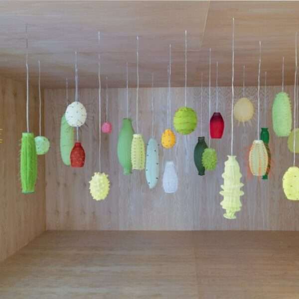 a room with numerous illuminated suspended lights, all loosely reminiscent of tropical fruits