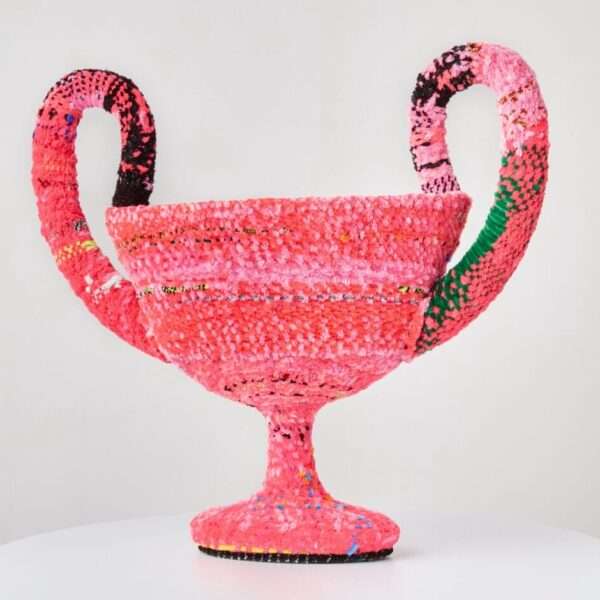 a vessel made from woven pipe cleaners in shades of pink and pops of green