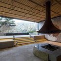The stove and stone wall in the hotel lobby are custom-made by Japanese stonemason Izumiya Sekizaiten. Image © Nikken Sekkei Beijing Xitan Hotel Landscape Design / Nikken Sekkei - Interior Photography