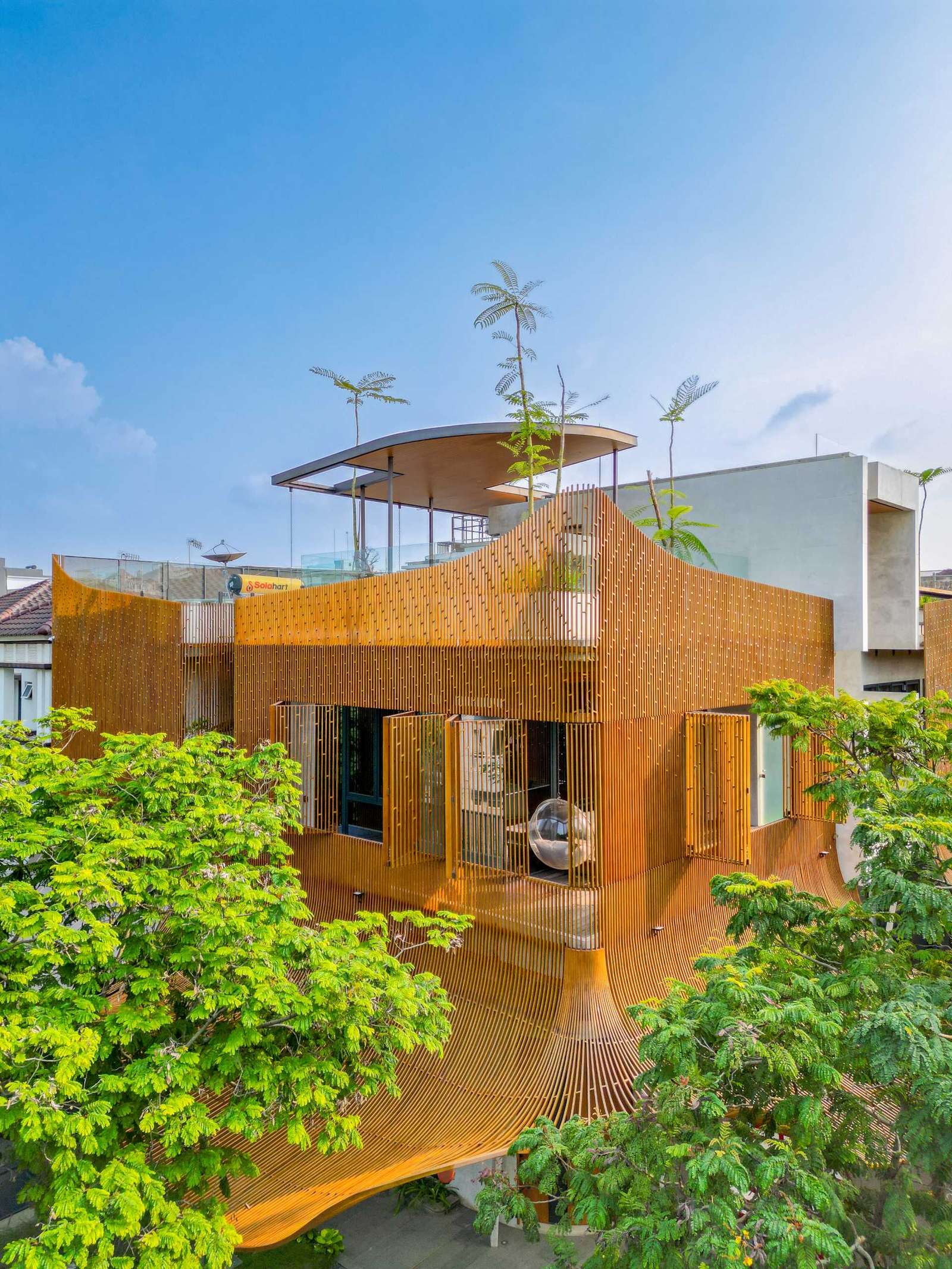 A modern home with operable steel fins on its exterior facade.