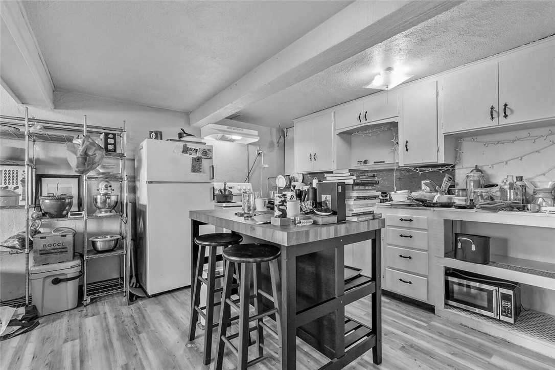 Before - a dated lower level with kitchenette.