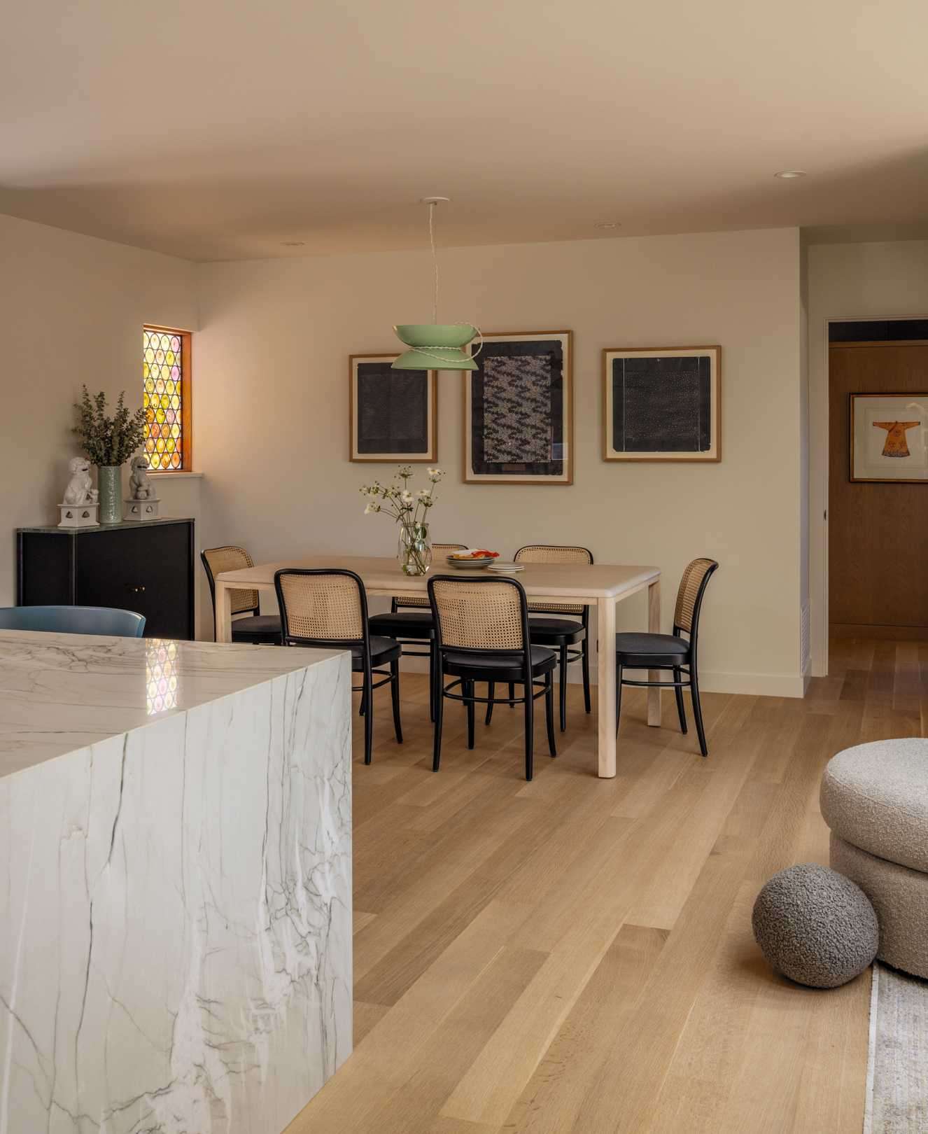 Custom stained glass windows cast playful shadows and pops of color to the new dining room.