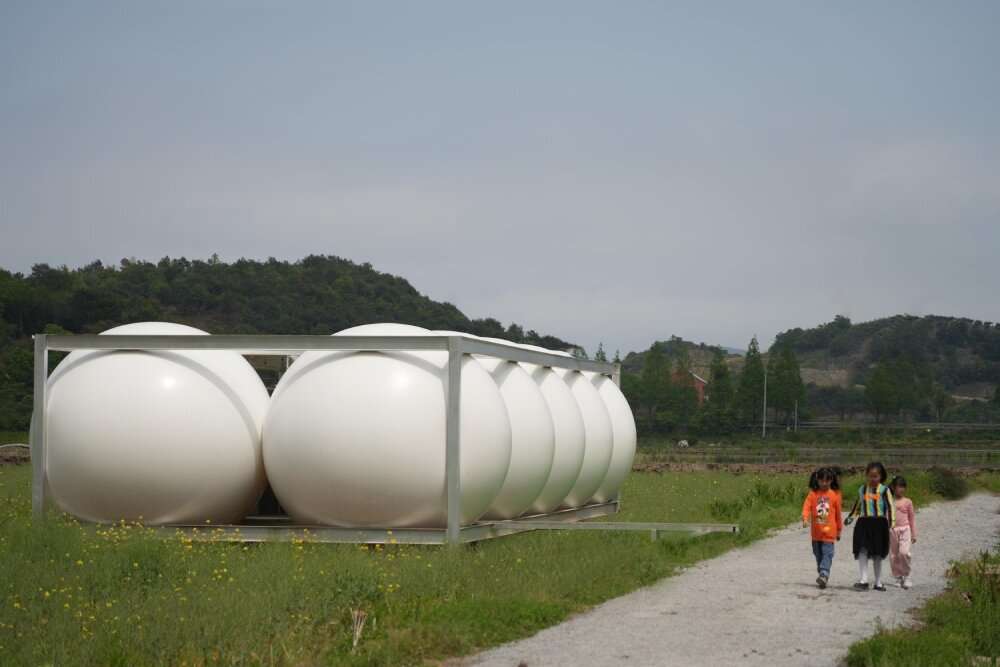 trio of inflated pavilions create rural café, cinema, and library amid rice fields in china