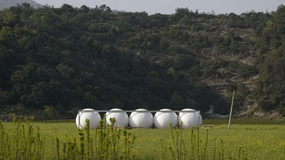 trio of inflated pavilions create rural café, cinema, and library amid rice fields in china