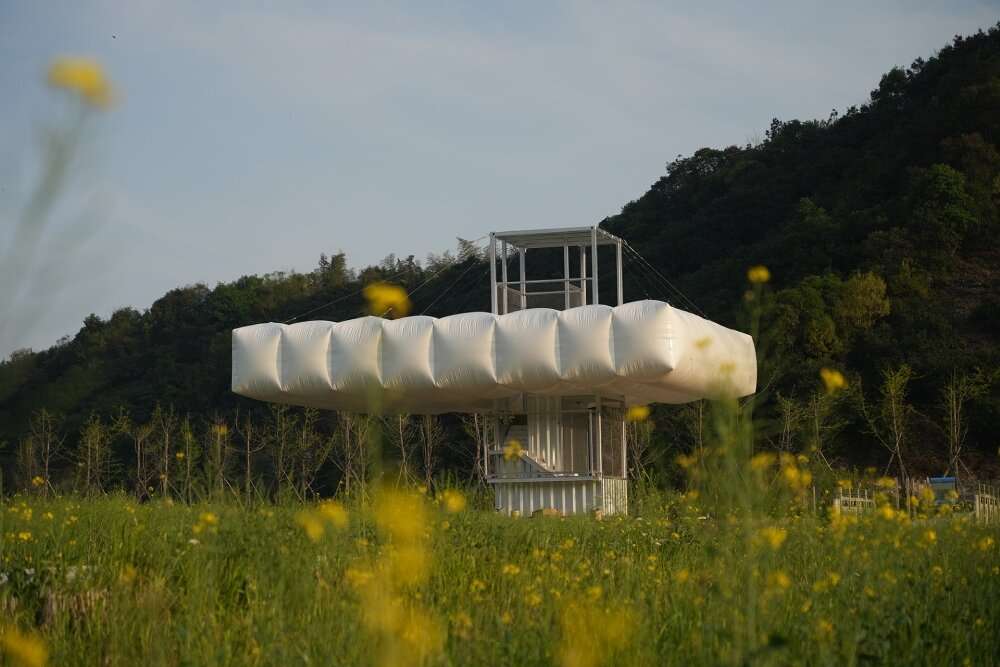 trio of inflated pavilions create rural café, cinema, and library amid rice fields in china