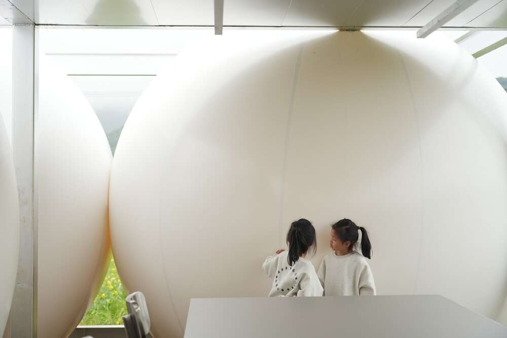 trio of inflated pavilions create rural café, cinema, and library amid rice fields in china