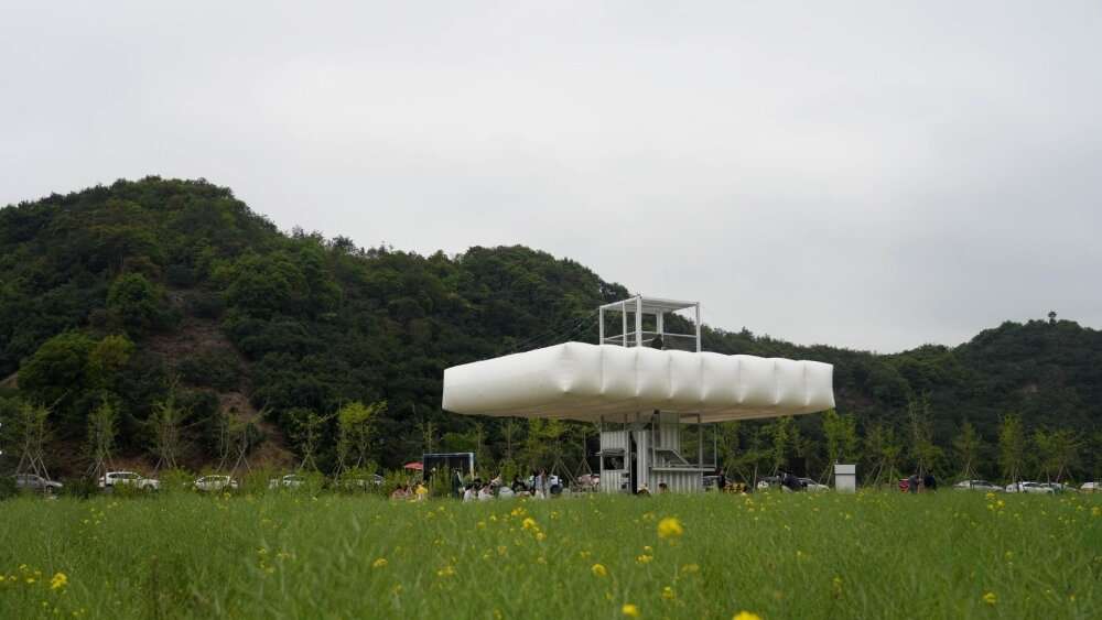 trio of inflated pavilions create rural café, cinema, and library amid rice fields in china