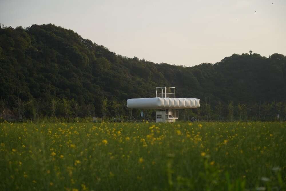 trio of inflated pavilions create rural café, cinema, and library amid rice fields in china