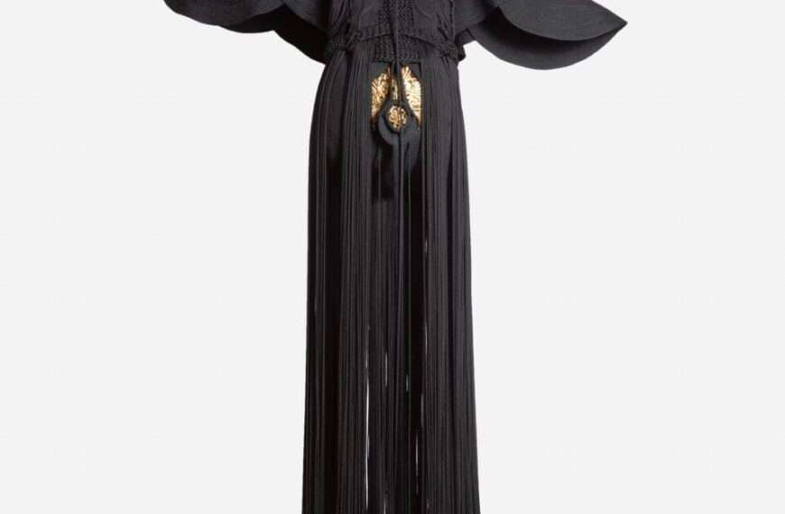 a sculpture made from black cord, thread, and metal in the form of a figure or long, dramatic garment