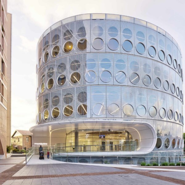 A modern library with a round design, whose exterior facade is covered in matching round windows.