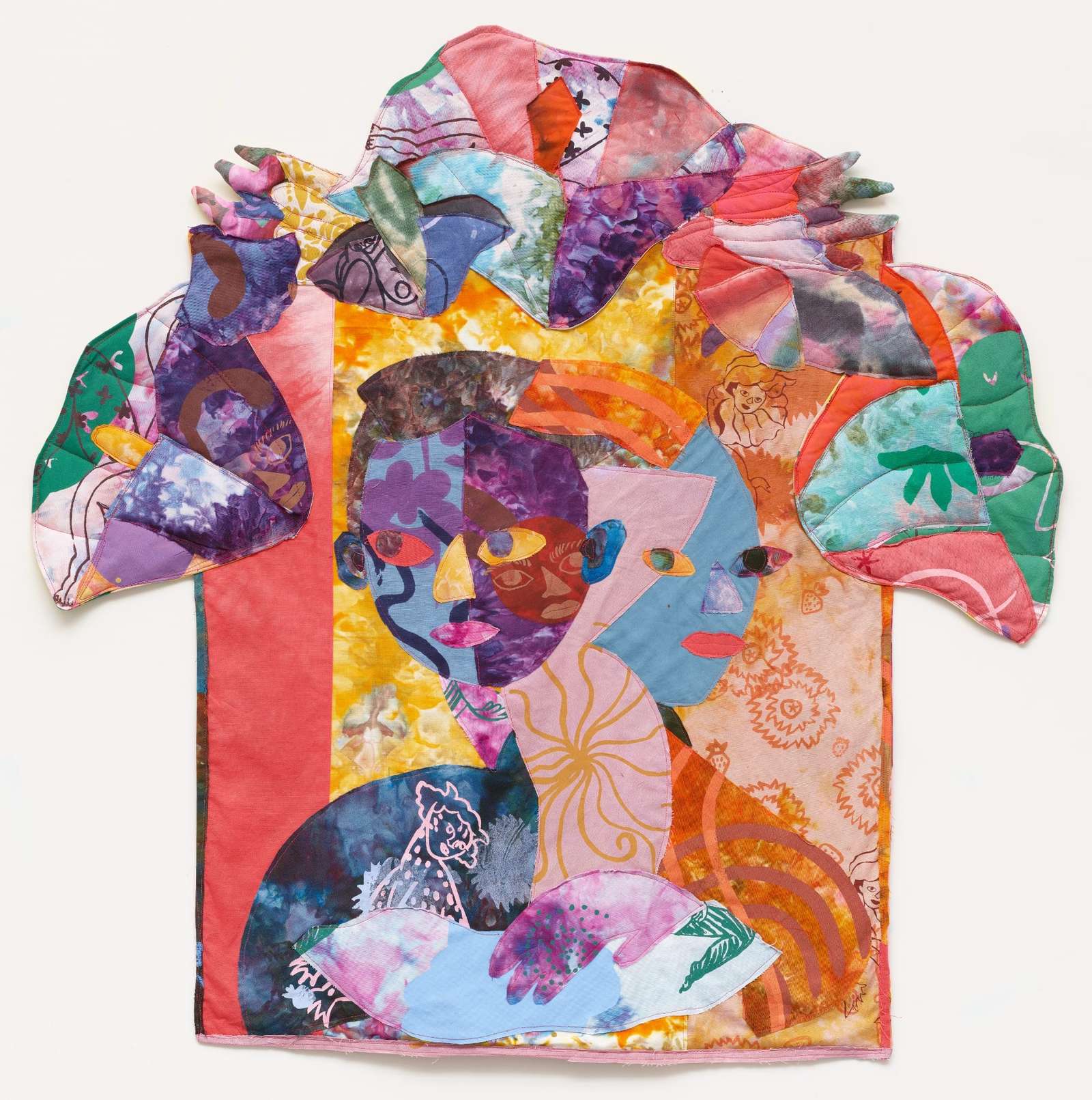 a textile portrait of a woman in vivid, patterned fabrics