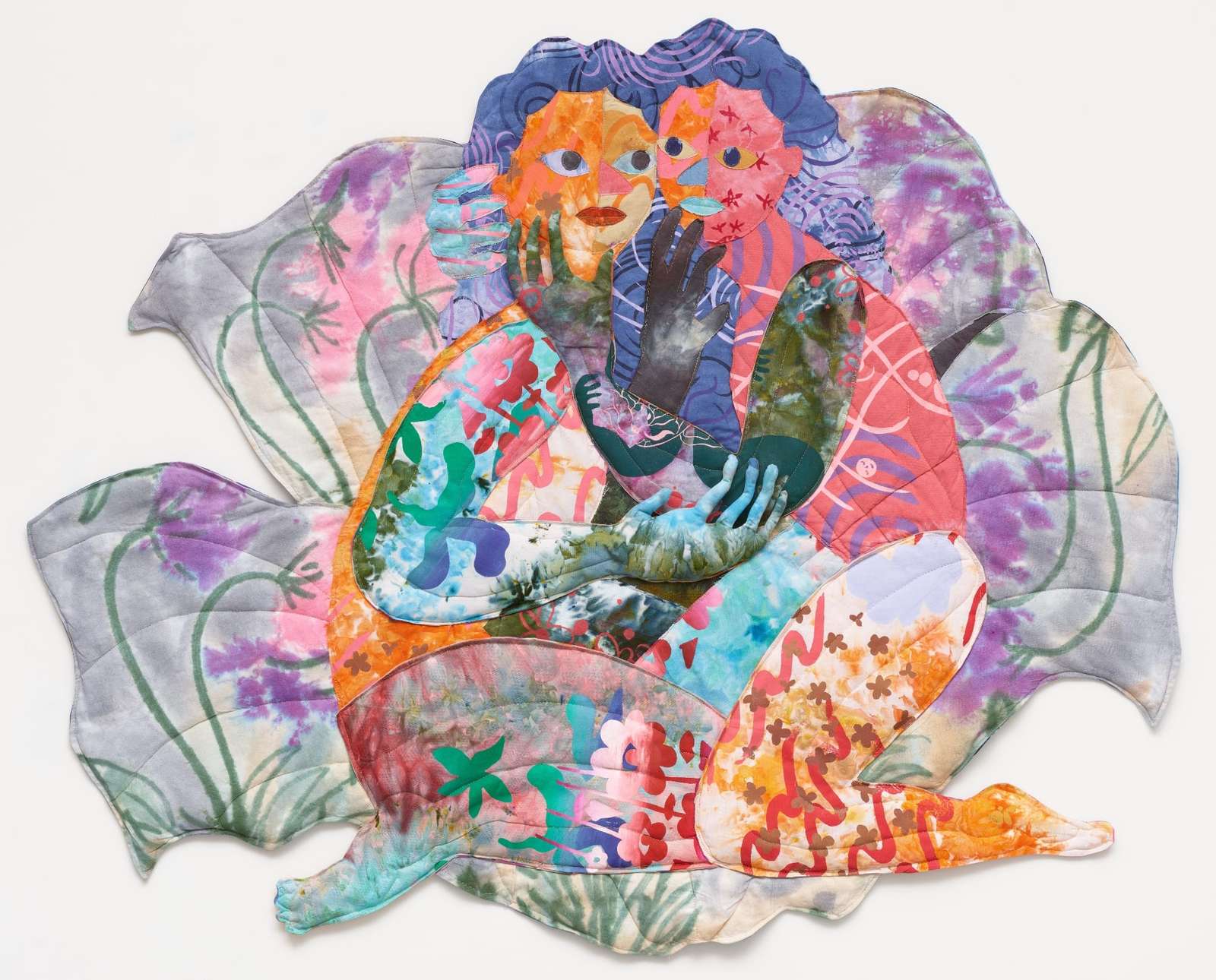 a textile portrait of two women in vivid, patterned fabrics