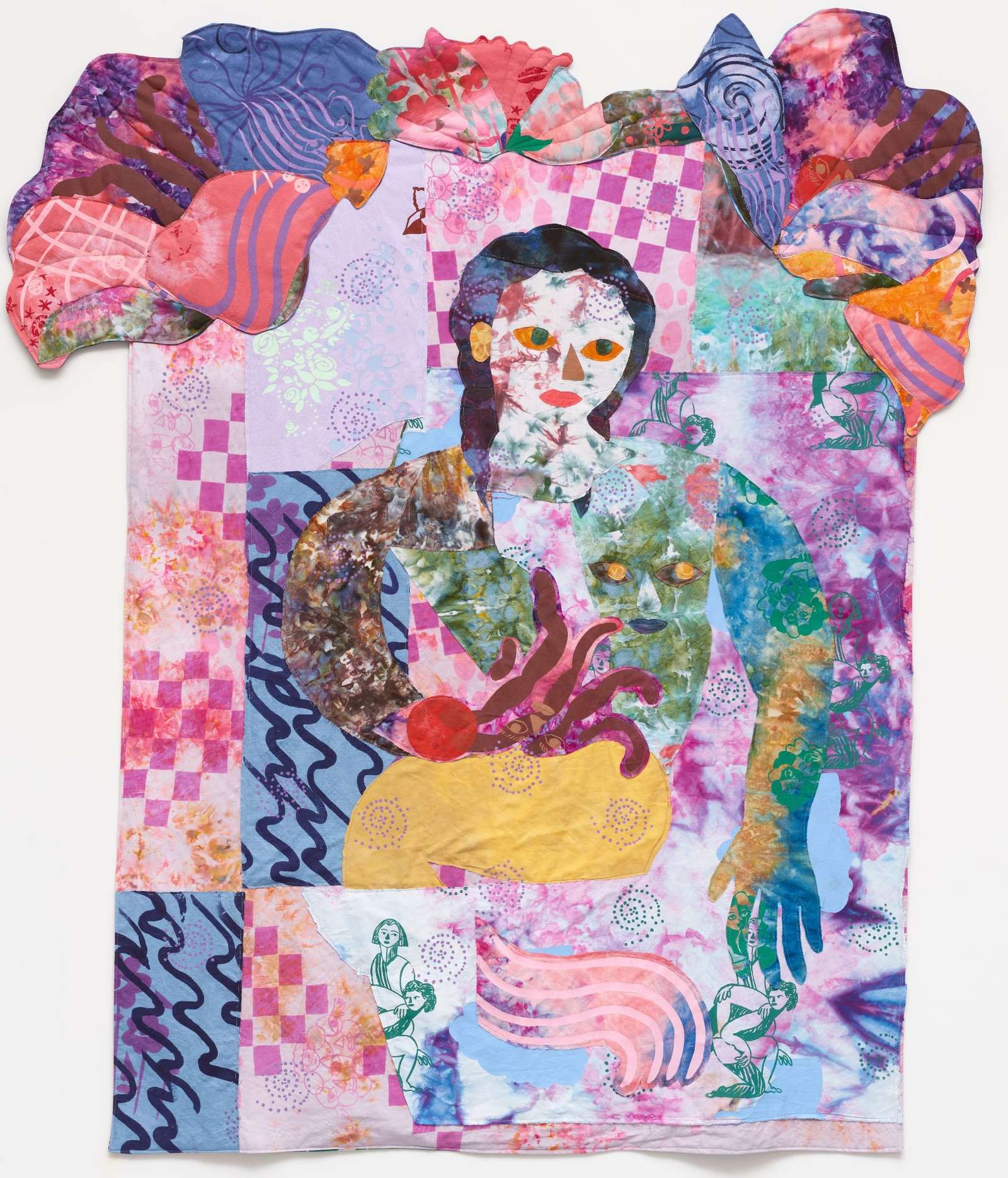 a textile portrait of a woman in vivid, patterned fabrics