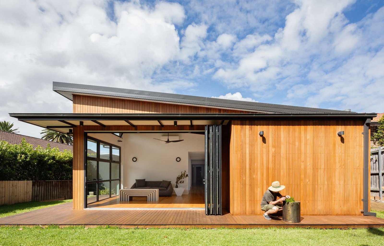 Natural timber, folding doors and soft transitions define this serene house extension designed for flexible, open-air living.