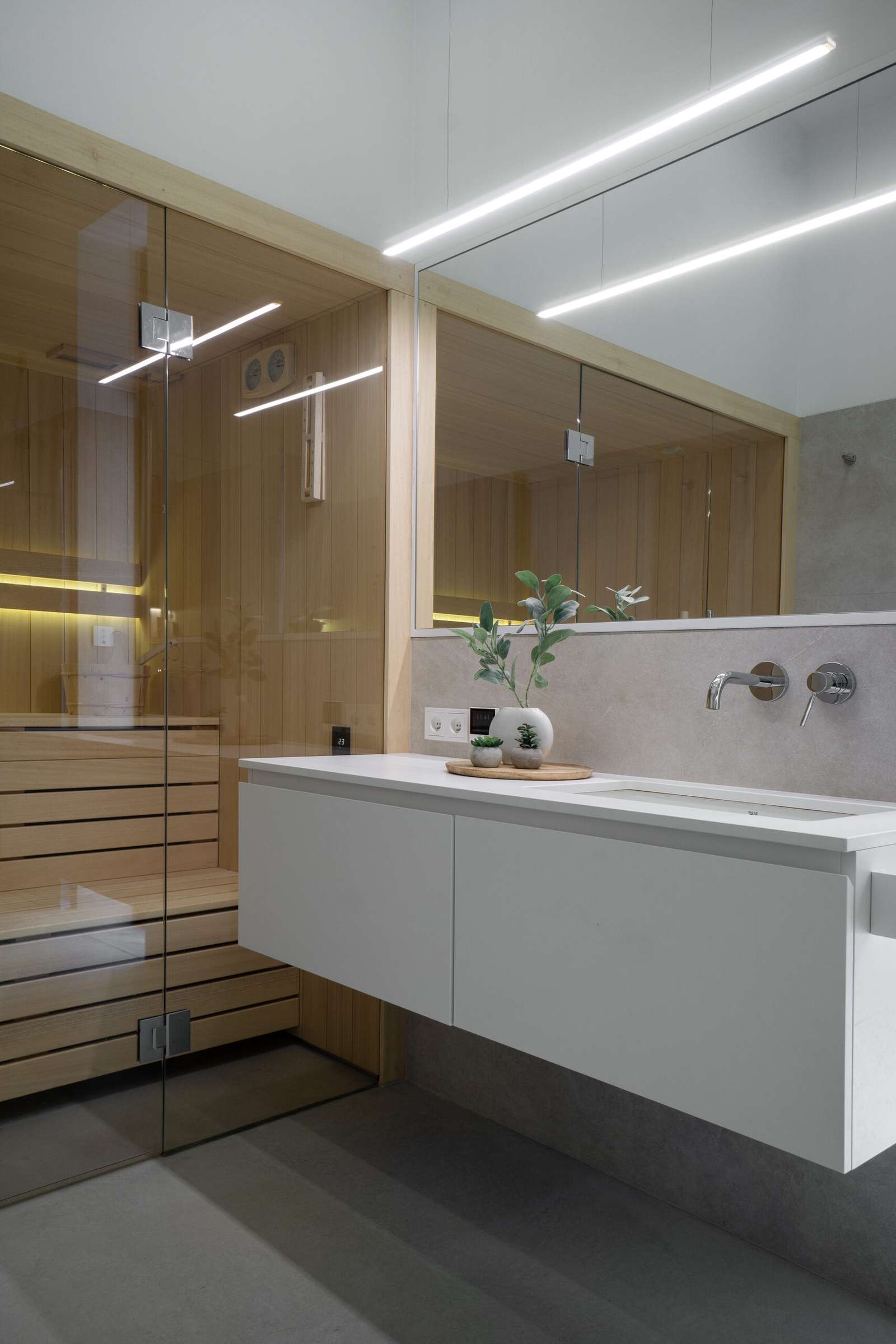 In this modern bathroom there's a walk-in shower, a floating vanity, and a sauna.