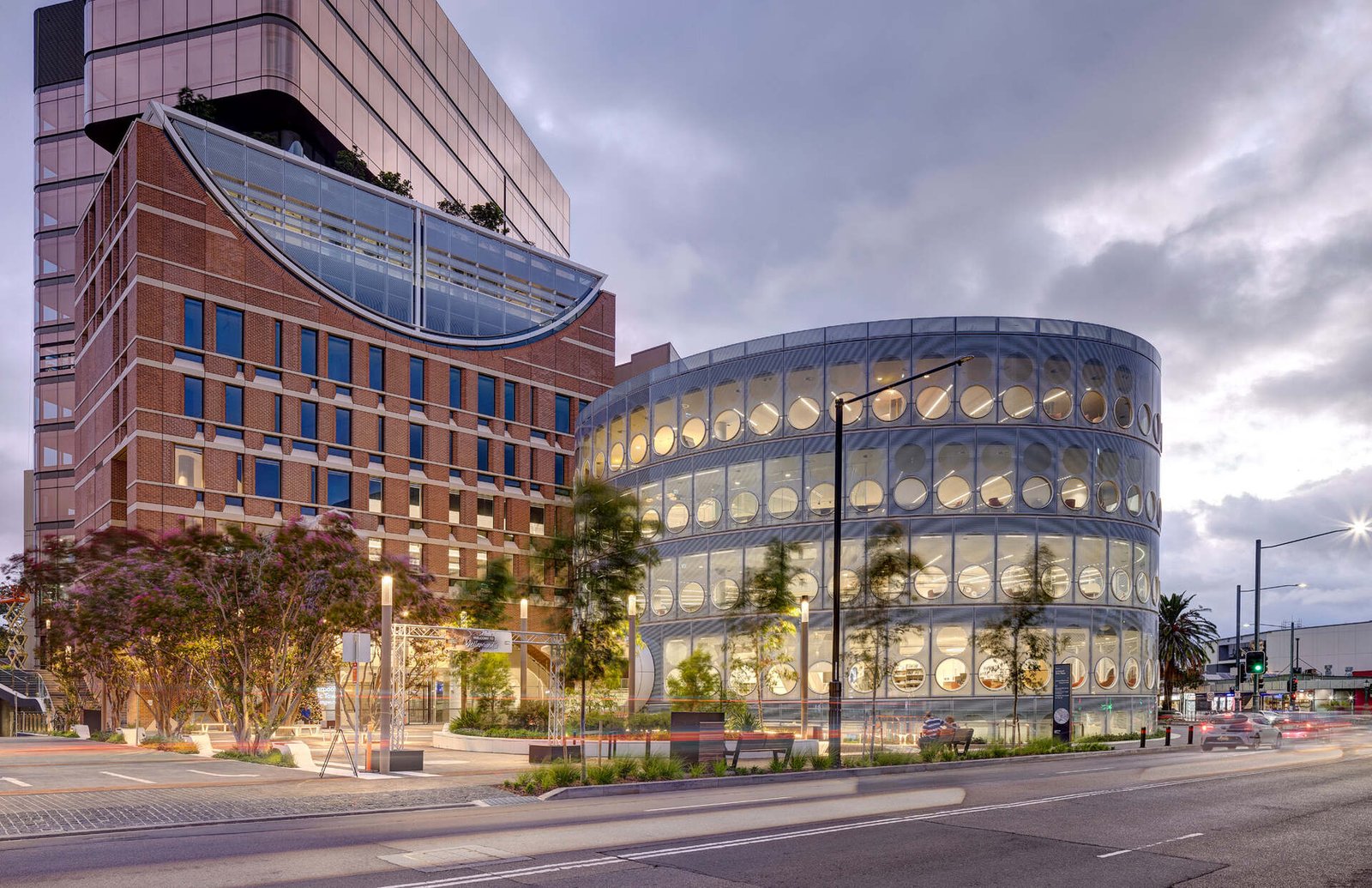 A modern library with a round design, whose exterior facade is covered in matching round windows.
