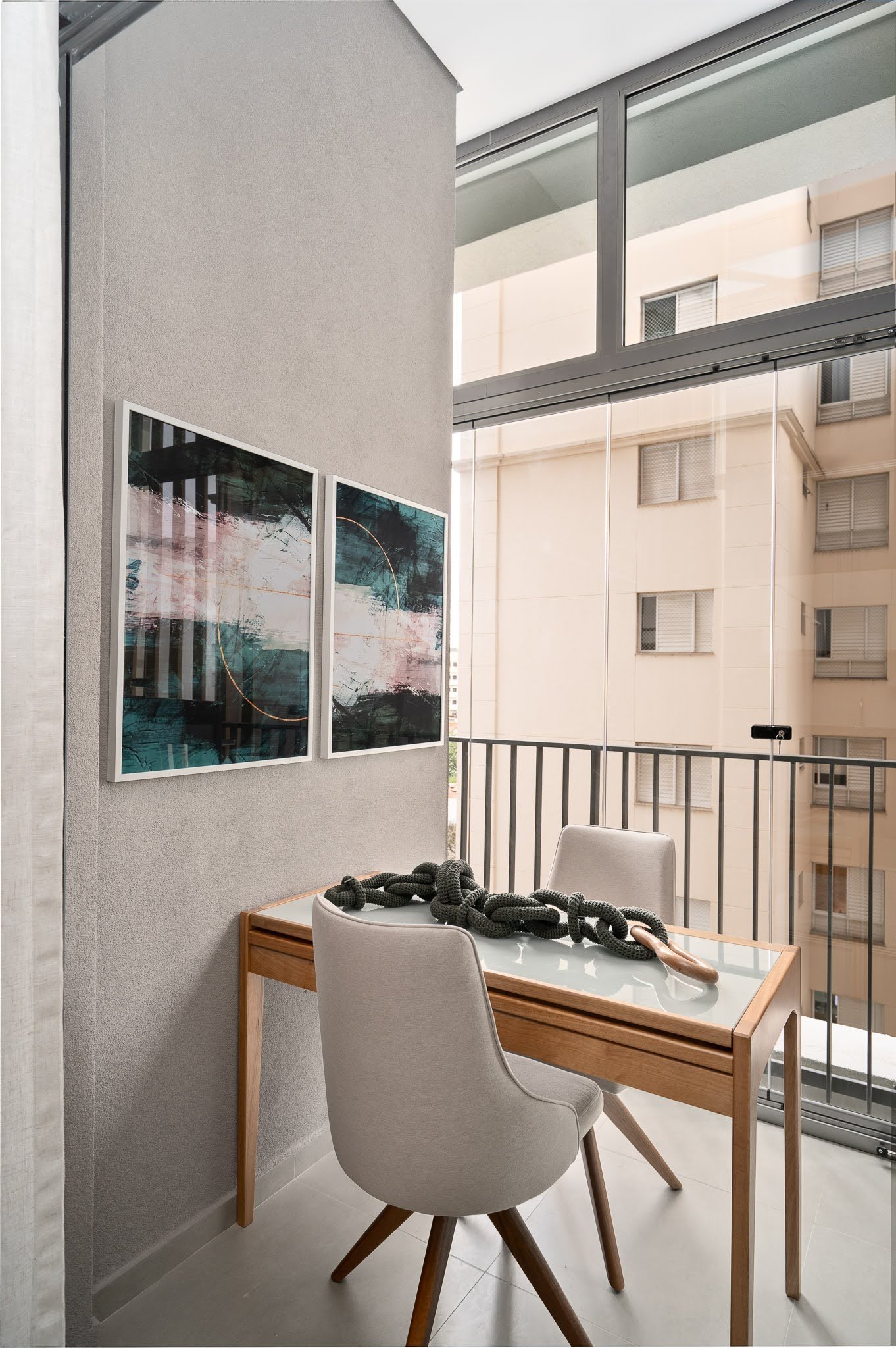 A small enclosed balcony decorated to complement the interior design of the apartment.