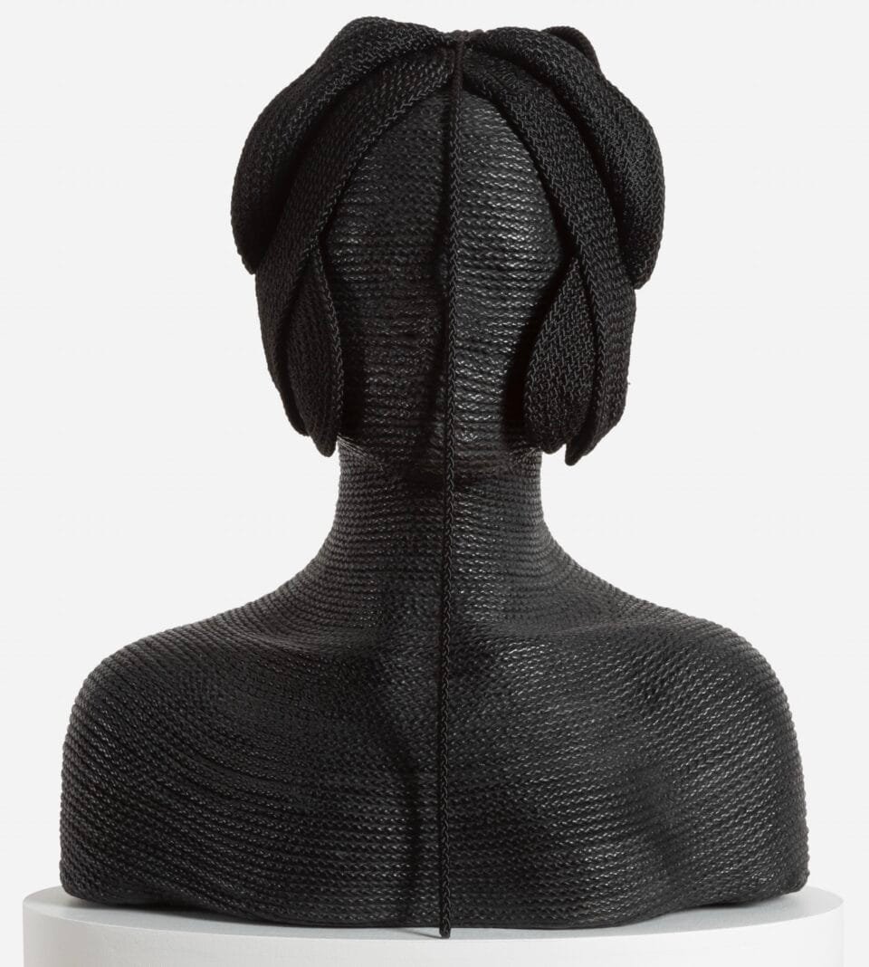 a sculpture made from black cord in the form of the head and shoulders of a figure