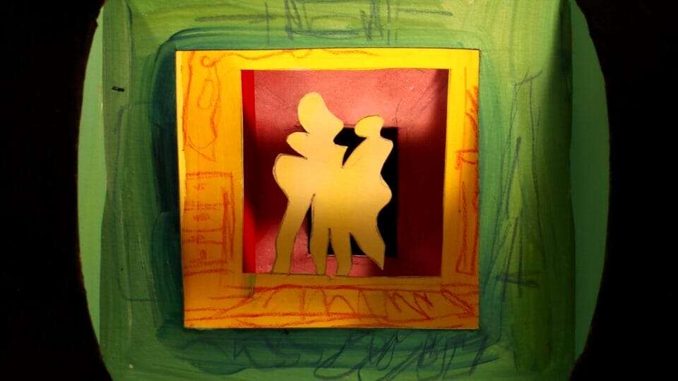 a layered assemblage of paper cut shapes, resembling two figures standing in a hallway