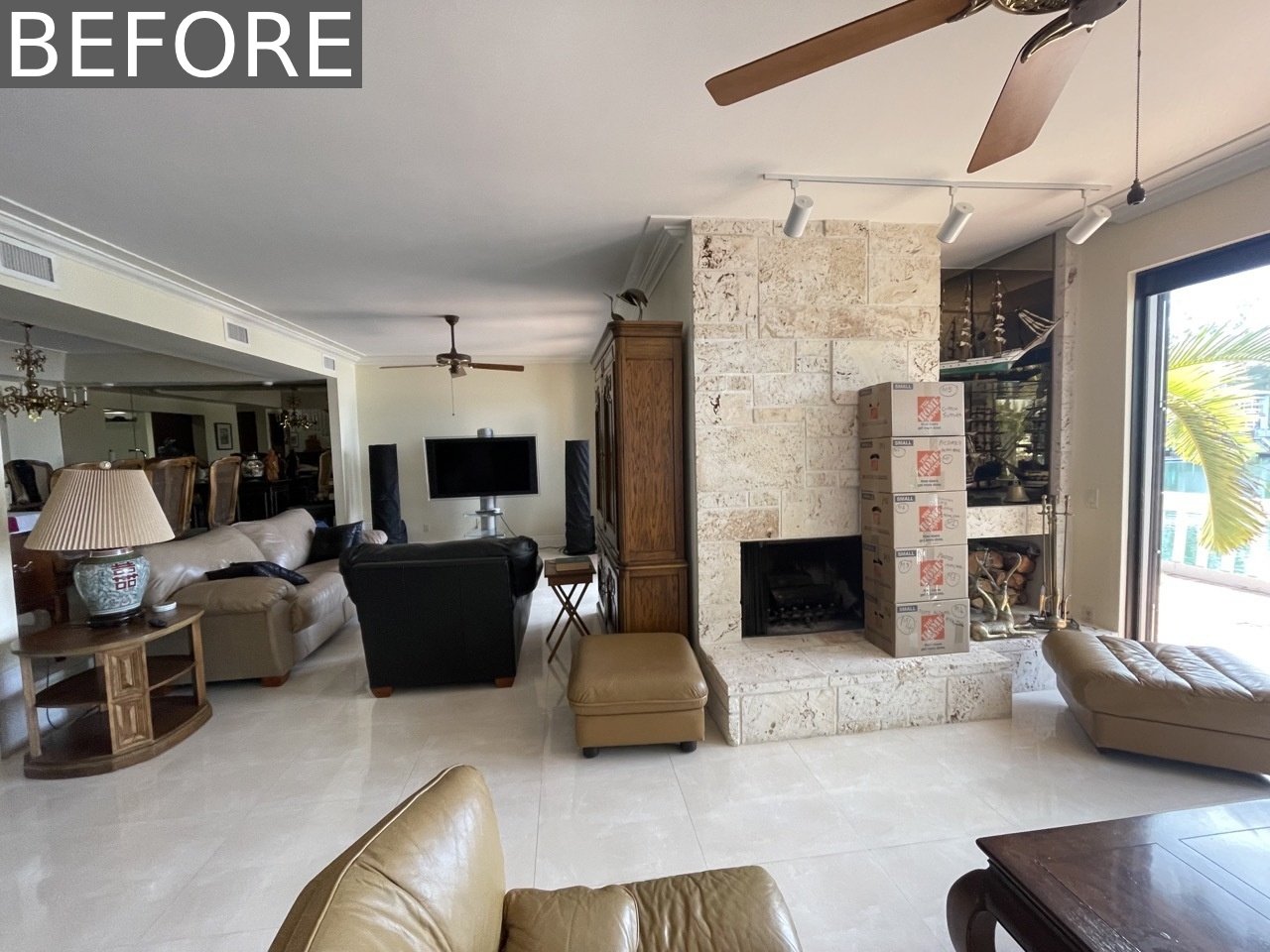 BEFORE - Originally, the living room was divided by a dated, tile-clad fireplace with adjacent wood storage and shelving, elements that visually split the space in two. The renovation reimagined this layout, keeping the dual zones but replacing heavy partitions with organic touches