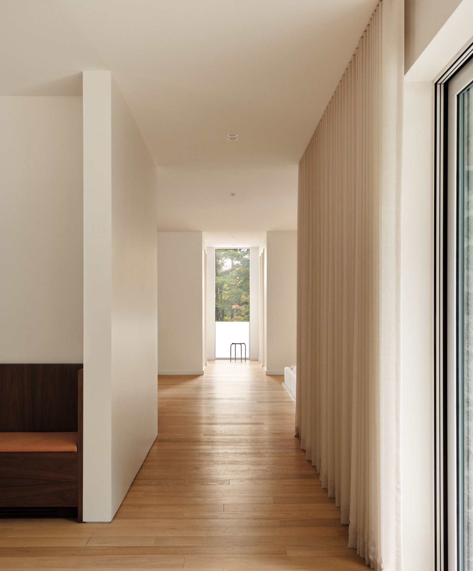 Throughout the home, flooring is treated as both backdrop and statement. From the slate-inspired ceramic in the vestibule to the pale oak planks in living spaces, each surface supports the home's gentle rhythm. These subtle choices add texture without overpowering the architecture.