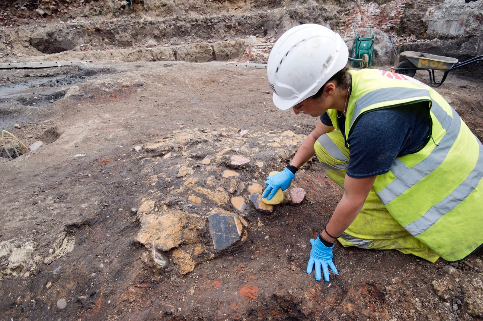 an archaeologist uncovers fragments of an ancient Roman fresco